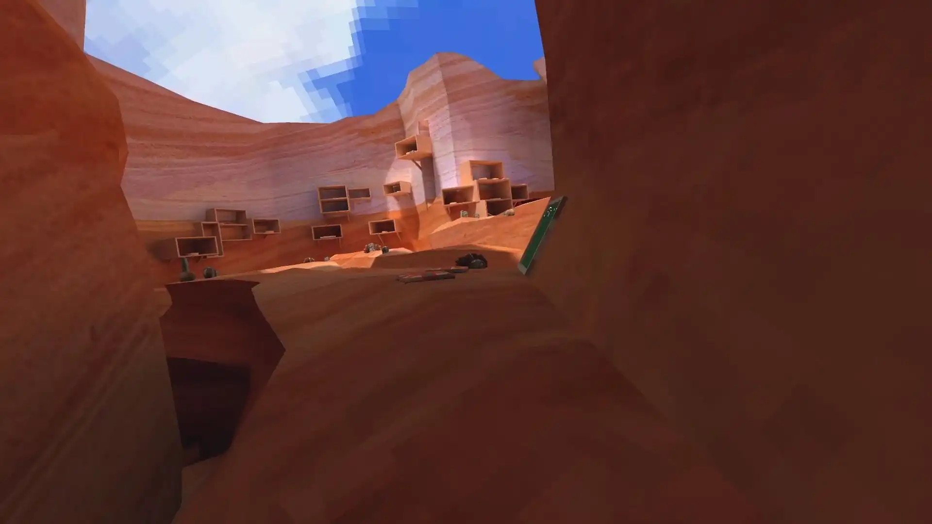 Sandstone canyon walls with stacked ledges and a bright blue sky